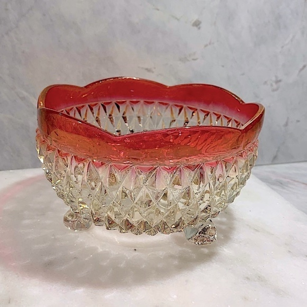 Cut glass footed bowl with scalloped red trim